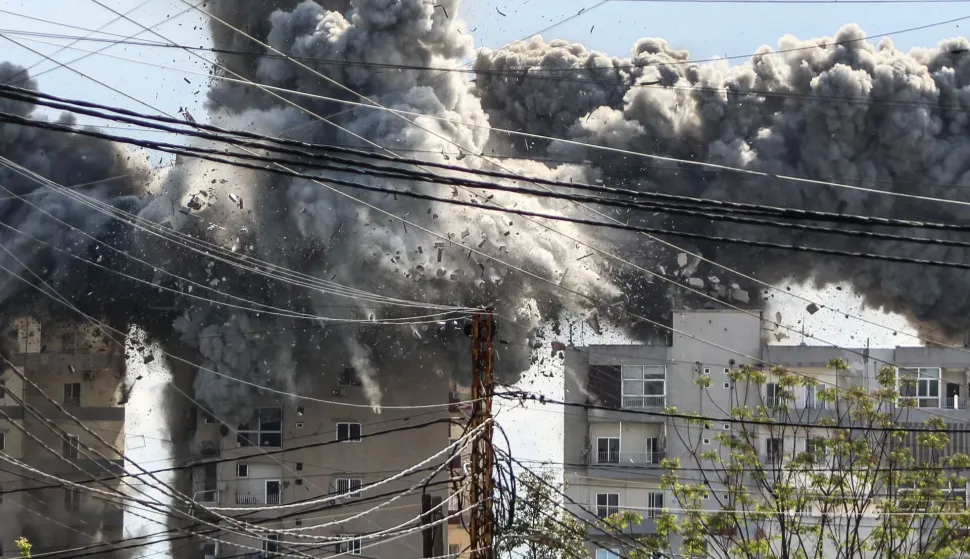 Smoke and debris rise after a building is hit by an Israeli airstrike in the area of Abbasiyeh, on the outskirts of the southern Lebanese city of Tyre, on April 8, 2026. Lebanon's army warned people against returning to the country's south on April 8, where the Israeli military is still launching attacks, as Israel said the ceasefire with Iran did not include its conflict with Hezbollah. (Photo by Kawnat HAJU/AFP)