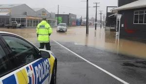 epa10465753 A handout photo made available by the New Zealand Police assisting motorists around flood waters in Whangārei, New Zealand, issued 13 February 2023. The New Zealand government is considering a national state of emergency, with tens of thousands of homes without power and Cyclone Gabrielle's worst still to come as the storm surges south. EPA/NEW ZEALAND POLICE HANDOUT AUSTRALIA AND NEW ZEALAND OUT HANDOUT EDITORIAL USE ONLY/NO SALES/NO ARCHIVES