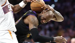 LOS ANGELES, CALIFORNIA - APRIL 10: LeBron James #23 of the Los Angeles Lakers battles Ryan Dunn #0 of the Phoenix Suns for a loose ball during the second half of a game at Crypto.com Arena on April 10, 2026 in Los Angeles, California. Sean M. Haffey/Getty Images/AFP (Photo by Sean M. Haffey/GETTY IMAGES NORTH AMERICA/Getty Images via AFP)