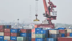General view shows containers stacked up at Jun Gong Road container terminal in Shanghai on April 10, 2026. (Photo by HECTOR RETAMAL/AFP)