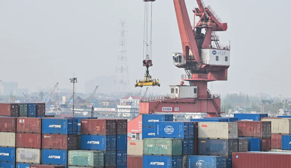 General view shows containers stacked up at Jun Gong Road container terminal in Shanghai on April 10, 2026. (Photo by HECTOR RETAMAL/AFP)