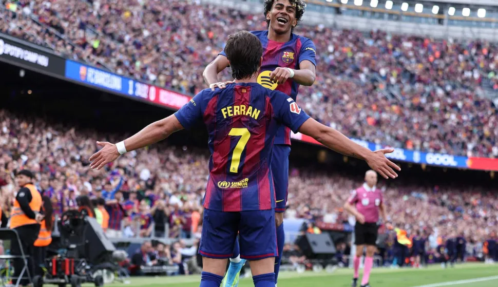 Barcelona's Spanish forward #07 Ferran Torres celebrates with Barcelona's Spanish forward #10 Lamine Yamal scoring his team's second goal during the Spanish league football match between FC Barcelona and RCD Espanyol at the Camp Nou stadium in Barcelona on April 11, 2026. (Photo by Josep LAGO/AFP)