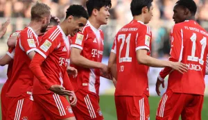 Bayern Munich's German midfielder #10 Jamal Musiala (3rd L) celebrates scoring the opening goal with his teammates during the German first division Bundesliga football match between FC St Pauli and FC Bayern Munich in Hamburg, northern Germany, on April 11, 2026. (Photo by Ibo OT/AFP)/DFL REGULATIONS PROHIBIT ANY USE OF PHOTOGRAPHS AS IMAGE SEQUENCES AND/OR QUASI-VIDEO