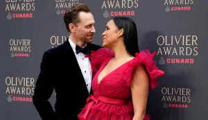 British actor Tom Hiddleston and British actress Zawe Ashton pose on the green carpet upon arrival to attend The Olivier Awards at the Royal Albert Hall in central London on April 12, 2026. (Photo by CARLOS JASSO/AFP)