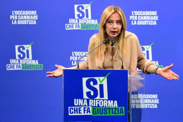 (FILES) Italy's Prime Minister Giorgia Meloni speaks during a campaign meeting of Italian right wing party Brothers of Italy (Fratelli d'Italia) (Fdi) to support the "Yes" to Justice referendum, in Milan on March 12, 2026. Italian Prime Minister Giorgia Meloni on March 23, 2026 conceded defeat in a referendum on her justice reforms, while confirming she would not hand in her resignation. (Photo by Stefano RELLANDINI/AFP)