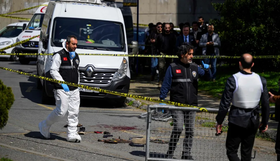 TOPSHOT - Police officials gather outside The Israeli Consulate in Istanbul on April 7, 2026, following a shootout between gunmen and police. One gunman was killed and two others were wounded in a shootout with police outside the Israeli consulate in Istanbul, the local governor said, adding two officers were lightly wounded (Photo by Yasin AKGUL/AFP)