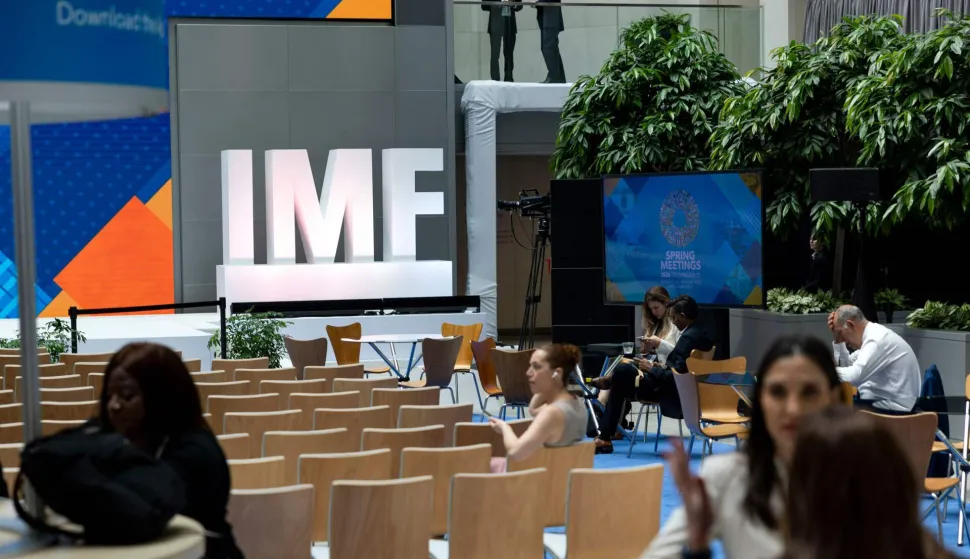 People gather in the atrium of the International Monetary Fund (IMF) building during the first day of the 2026 Spring Meetings of the IMF and the World Bank Group (WBG) in Washington, DC, on April 13, 2026. (Photo by Kent Nishimura/AFP)