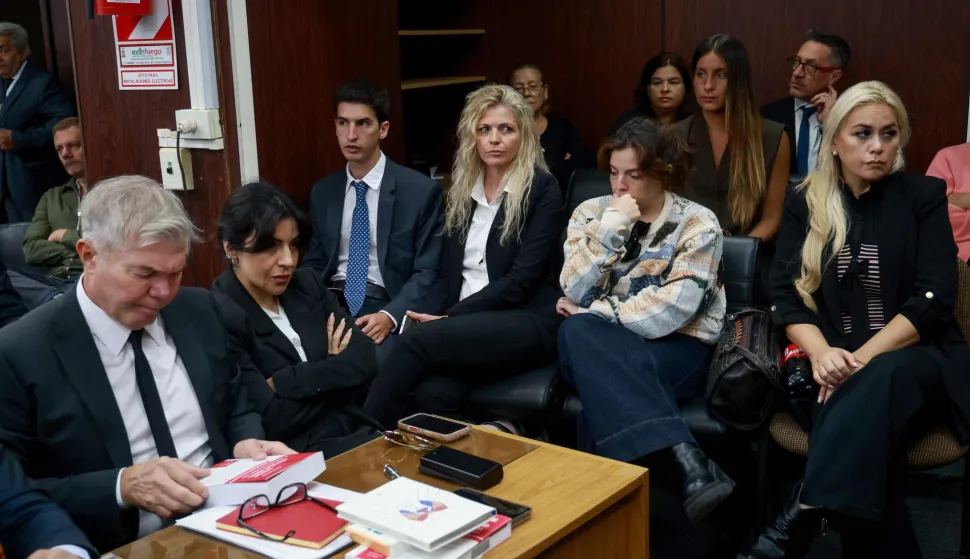 Dalma Maradona (2-R) and Gianinna Maradona (2-L), daughters of Argentine football legend Diego Maradona and his former partner, Veronica Ojeda (R), are seen at a courthouse during a preliminary hearing in a trial over his death in San Isidro, outskirts of Buenos Aires on April 14, 2026. (Photo by Tomas CUESTA/AFP)