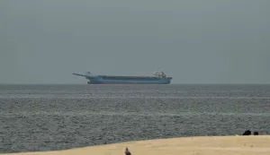 A ship is seen in the Persian Gulf off the coast of Sharjah the day after the failure of US-Iran peace talks on April 13, 2026. The failure of US-Iran peace talks has left the US President with several unpalatable options, as analysts say his order to blockade the strategic Strait of Hormuz could further complicate his next move on April 12, 2026. Any hopes that US Vice President would emerge from the marathon day of negotiations with top Iranian officials with a deal to end a war that has rippled across the Middle East were dashed when he left hosts Pakistan emptyhanded. (Photo by AFP)