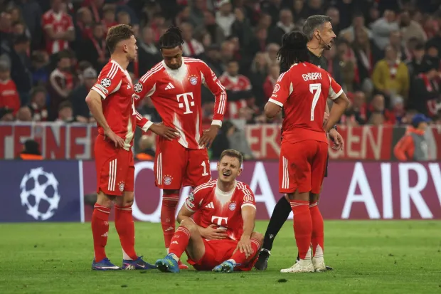 Bayern Munich's Croatian defender #44 Josip Stanisic (C, bottom) reacts in pain in the ground during the UEFA Champions League quarter-final second leg football match between FC Bayern Munich and Real Madrid in Munich, southern Germany, on April 15, 2026. (Photo by Karl-Josef HILDENBRAND/AFP)