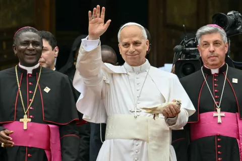 Pope Leo XIV (C) holds a white dove before releasing it after he met with the community of Bamenda at Saint Joseph's Cathedral in Bamenda, on the fourth day of an 11-day apostolic journey to Africa, on April 16, 2026. (Photo by Alberto PIZZOLI/AFP)