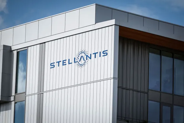 A photo shows a company logo at the Stellantis multinational car manufacturer's plant in Poissy, west of Paris, on April 15, 2026. Automaker Stellantis will cease automobile production at its historic Poissy plant (Yvelines) after 2028. The site will be converted into a parts manufacturing and vehicle dismantling center, retaining 1,000 of the current 2,000 jobs, the group announced on April 16, 2026. (Photo by Simon Wohlfahrt/AFP)