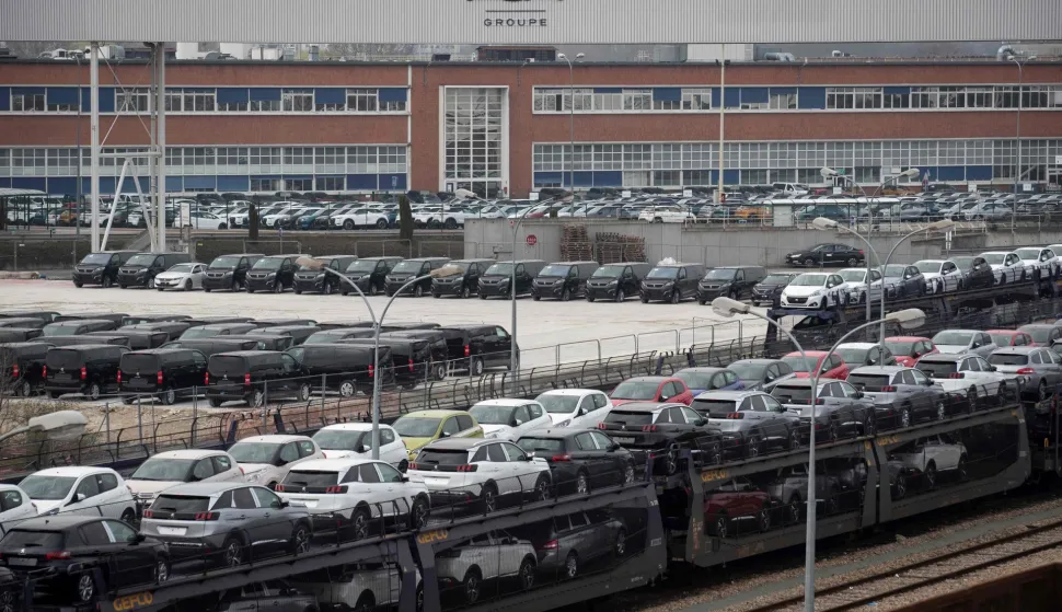 (FILES) Vehicles stand parked in a lot in front of the French automaker PSA Peugeot-Citroen Poissy plant at Poissy, outside Paris on March 28, 2019. Automaker Stellantis will cease automobile production at its historic Poissy plant (Yvelines) after 2028. The site will be converted into a parts manufacturing and vehicle dismantling center, retaining 1,000 of the current 2,000 jobs, the group announced on April 16, 2026. (Photo by Thomas SAMSON/AFP)