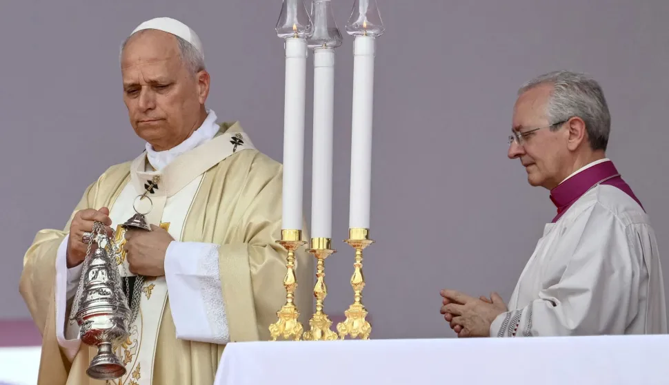 CORRECTION/Pope Leo XIV (L) swings the thurible as he leads a Holy Mass in Kilamba on the seventh day of an 11-day apostolic journey to Africa, on April 19, 2026. (Photo by Alberto PIZZOLI/AFP)/?The erroneous mention[s] appearing in the metadata of this photo by Alberto PIZZOLI has been modified in AFP systems in the following manner: [ Kilamba] instead of [Kalimba]. Please immediately remove the erroneous mention[s] from all your online services and delete it (them) from your servers. If you have been authorized by AFP to distribute it (them) to third parties, please ensure that the same actions are carried out by them. Failure to promptly comply with these instructions will entail liability on your part for any continued or post notification usage. Therefore we thank you very much for all your attention and prompt action. We are sorry for the inconvenience this notification may cause and remain at your disposal for any further information you may require.?