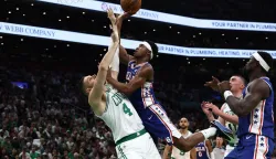 BOSTON, MA - APRIL 19: VJ Edgecombe #77 of the Philadelphia 76ers runs into Nikola Vucevic #4 of the Boston Celtics as he goes to the basket during the second quarter of Game One of the Eastern Conference First Round NBA Playoffs at TD Garden on April 19, 2026 in Boston, Massachusetts. NOTE TO USER: User expressly acknowledges and agrees that, by downloading and/or using this Photograph, user is consenting to the terms and conditions of the Getty Images License Agreement. (Photo By Winslow Townson/Getty Images) (Photo by Winslow Townson/GETTY IMAGES NORTH AMERICA/Getty Images via AFP)