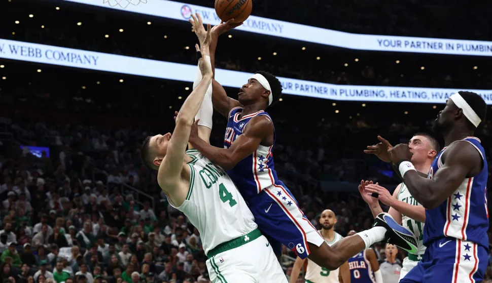 BOSTON, MA - APRIL 19: VJ Edgecombe #77 of the Philadelphia 76ers runs into Nikola Vucevic #4 of the Boston Celtics as he goes to the basket during the second quarter of Game One of the Eastern Conference First Round NBA Playoffs at TD Garden on April 19, 2026 in Boston, Massachusetts. NOTE TO USER: User expressly acknowledges and agrees that, by downloading and/or using this Photograph, user is consenting to the terms and conditions of the Getty Images License Agreement. (Photo By Winslow Townson/Getty Images) (Photo by Winslow Townson/GETTY IMAGES NORTH AMERICA/Getty Images via AFP)