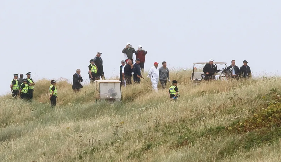 epa06890320 US President Donald J. Trump (3-R) after playing a shot during a round of golf at Trump Turnberry golf resort in Turnberry, Scotland, 15 July 2018. Trump is on a three-day working visit to the United Kingdom, his first trip to the country as US president. EPA/ROBERT PERRY BEST QUALITY AVAILABLE