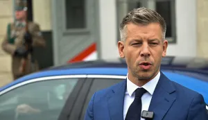 Hungary's Prime minister-elect Peter Magyar speaks as he arrives at the entrance of the Presidential Sandor Palace in Budapest on April 15, 2026 before meeting with Hungary's President and other parliamentary parties, two three days after general elections in Hungary. (Photo by Attila KISBENEDEK/AFP)