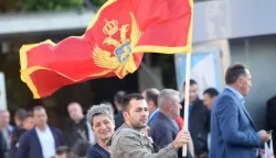 epa05321914 A man holds the Montenegrin flag at the Independence Square during the celebrations for the country's 10th anniversary of its Independence Day in Podgorica, Montenegro, 21 May 2016. EPA/BORIS PEJOVIC