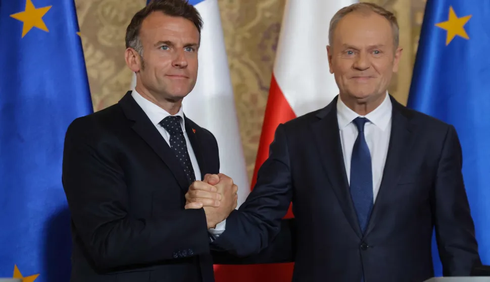 French President Emmanuel Macron (L) and Polish Prime Minister Donald Tusk shake hands at the end of a joint press conference at the Main Town Hall in Gdansk, Poland, on April 20, 2026 during the French President's one-day visit to Poland. (Photo by Ludovic MARIN/AFP)