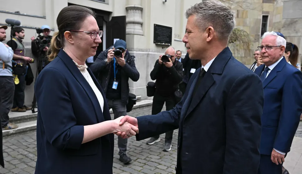 Hungary's Prime minister-elect Peter Magyar (R) is welcomed by Israel's ambassador to Hungary Maya Kadosh (L) as he arrives to attend a commemoration ceremony to mark the 82th anniversary of Hungarian Holocaust victims at the Holocaust Memorial Center in Budapest, Hungary on April 16, 2026. April 16, 2026 marks the 82th anniversary of the beginning of the Hungarian Holocaust during which some 600,000 Jewish Hungarians were deported to Nazi death camps in Austria, Germany and Poland. The Memorial Day of the Hungarian Victims of the Holocaust was established by the Ministry of Education in 2000 and is commemorated in schools, at memorial sites and by Jewish communities throughout the country. (Photo by Attila KISBENEDEK/AFP)