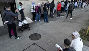 People wait in a long queue to enter the Consulate General of the Kingdom of Morocco in Bilbao, Spain, on April 15, 2026. Spain's left-wing government yesterday approved a decree expected to regularise around 500,000 undocumented migrants, said Prime Minister Pedro Sanchez, who has bucked a European trend cracking down on irregular immigration. (Photo by ANDER GILLENEA/AFP)