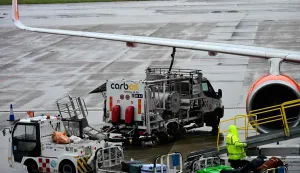 A worker loads luggage onto an Easyjet aircraft as a fuel truck "CarbOil" services the plane at Milan's Malpensa Airport on April 13, 2026. The European Commission said April 14, 2026 it fears Europe could face jet fuel supply issues "in the near future" with no end in sight to the Iran war roiling global energy markets. (Photo by Stefano Rellandini/AFP)