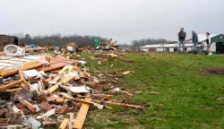 UNION CENTER, WISCONSIN - APRIL 15: Neighbors survey the damage to a home after a tornado on Tuesday along Raese Road on April 15, 2026 in Union Center, Wisconsin. The National Weather Service is tracking the tornado's path as severe weather threats remain from the southern Plains to the Upper Midwest and Great Lakes regions. Kayla Wolf/Getty Images/AFP (Photo by Kayla Wolf/GETTY IMAGES NORTH AMERICA/Getty Images via AFP)