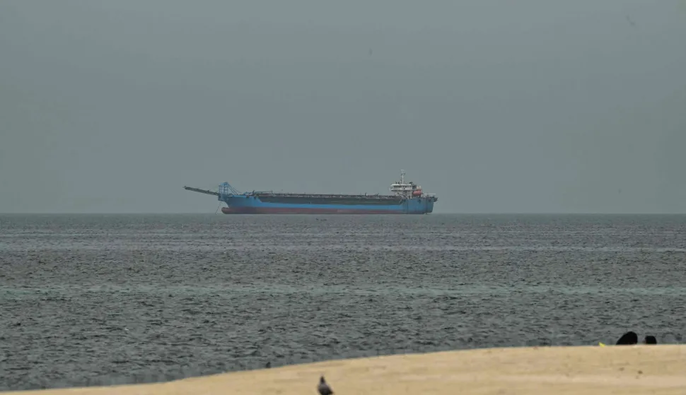 A ship is seen in the Persian Gulf off the coast of Sharjah the day after the failure of US-Iran peace talks on April 13, 2026. The failure of US-Iran peace talks has left the US President with several unpalatable options, as analysts say his order to blockade the strategic Strait of Hormuz could further complicate his next move on April 12, 2026. Any hopes that US Vice President would emerge from the marathon day of negotiations with top Iranian officials with a deal to end a war that has rippled across the Middle East were dashed when he left hosts Pakistan emptyhanded. (Photo by AFP)