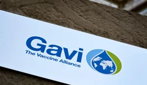 (FILES) This photograph shows a board bearing the logo of Gavi, the vaccine alliance at their headquarters in Geneva, on April 11, 2025. The head of a global vaccine organisation told AFP on April 24, 2026 that aid cuts by the US and other donors have forced it to slash its African malaria programme, threatening tens of thousands of children's lives."Our malaria programme has taken the heaviest cuts," said Sania Nishtar, CEO of Gavi, the Vaccine Alliance, and the impact "will likely be tens of thousands of children's lives lost".Washington last year cancelled its funding pledge of .58 billion to the Gavi alliance, which helps provide affordable jabs to developing countries. (Photo by Fabrice COFFRINI/AFP)