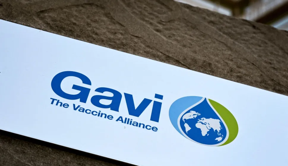 (FILES) This photograph shows a board bearing the logo of Gavi, the vaccine alliance at their headquarters in Geneva, on April 11, 2025. The head of a global vaccine organisation told AFP on April 24, 2026 that aid cuts by the US and other donors have forced it to slash its African malaria programme, threatening tens of thousands of children's lives."Our malaria programme has taken the heaviest cuts," said Sania Nishtar, CEO of Gavi, the Vaccine Alliance, and the impact "will likely be tens of thousands of children's lives lost".Washington last year cancelled its funding pledge of $1.58 billion to the Gavi alliance, which helps provide affordable jabs to developing countries. (Photo by Fabrice COFFRINI/AFP)