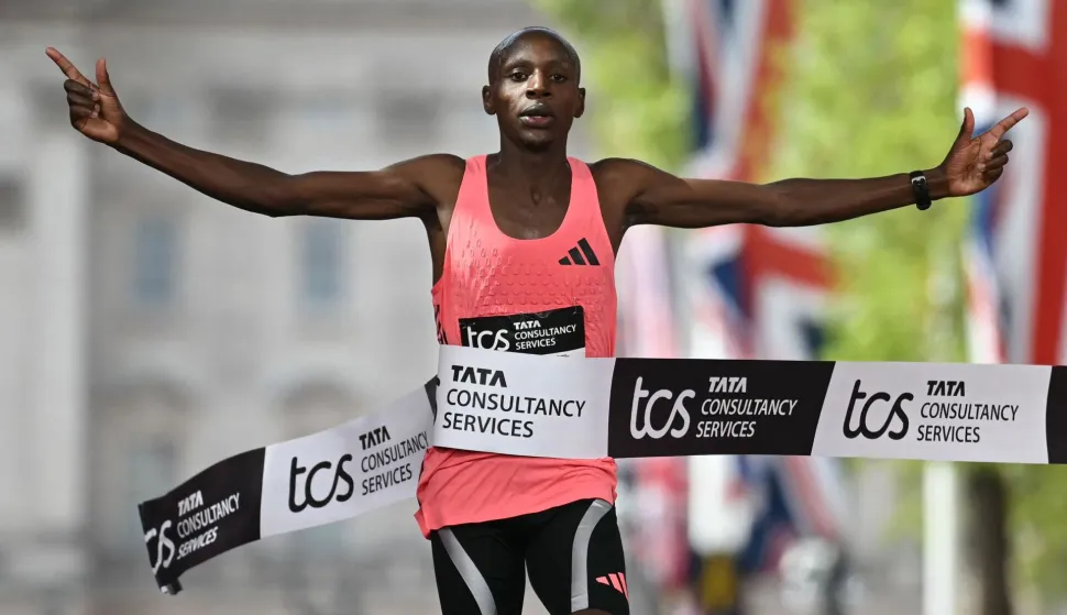TOPSHOT - Kenya's Sabastian Sawe crosses the line to win the men's race in a new world record time at the 2026 London Marathon in central London on April 26, 2026. Kenya's Sabastian Sawe broke the two-hour mark for the first time in history on Sunday in winning the London Marathon. (Photo by JUSTIN TALLIS/AFP)/?Restricted to editorial use - sponsorship of content subject to LMEL agreement?.