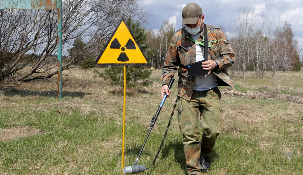 epa09152965 A dosimetrist walks past the radiation sign at the Chernobyl zone, Ukraine, 22 April 2021. Ukraine will mark the 35th anniversary of Chernobyl tragedy on 26 April 2021. The explosion of reactor 4 of the Chernobyl nuclear power plant in the early hours of 26 April 1986 is still regarded as the worst nuclear disaster no date. EPA/SERGEY DOLZHENKO