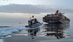 This photo obtained by AFP from the Iranian news agency Tasnim shows an Islamic Revolutionary Guard Corps (IRGC) boat allegedly taking part in an operation to seize ships attempting to cross the Strait of Hormuz, on April 21, 2026. Oil prices had been climbing earlier as investors worried about a lack of progress in ending the Middle East crisis, with Tehran keeping the Strait of Hormuz closed and the US maintaining a blockade of Iranian ports. (Photo by Meysam MIRZADEH/TASNIM NEWS/AFP)/