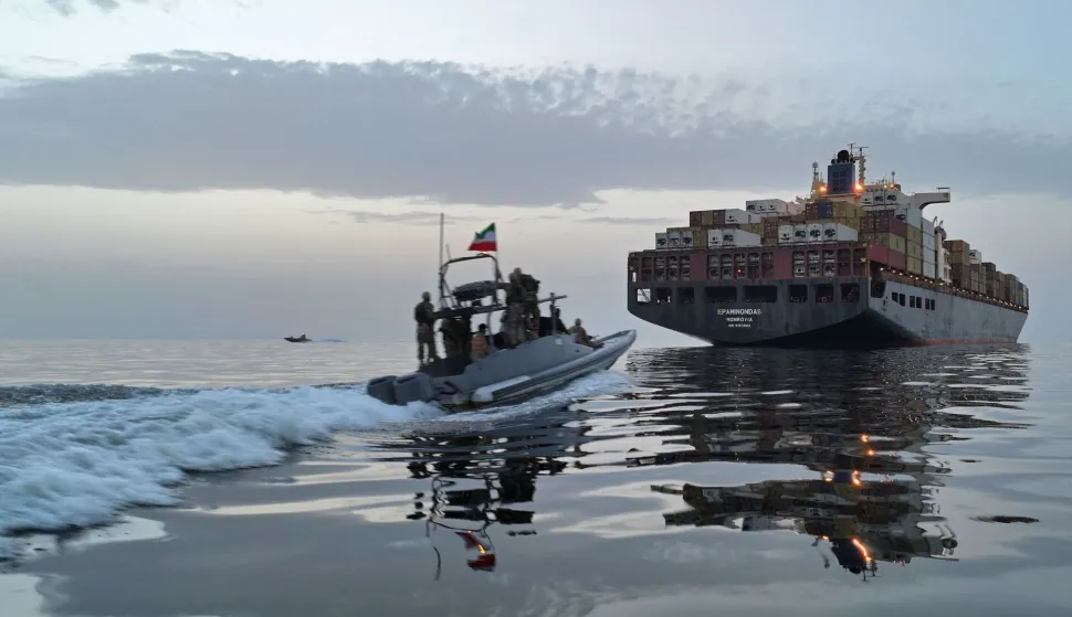 This photo obtained by AFP from the Iranian news agency Tasnim shows an Islamic Revolutionary Guard Corps (IRGC) boat allegedly taking part in an operation to seize ships attempting to cross the Strait of Hormuz, on April 21, 2026. Oil prices had been climbing earlier as investors worried about a lack of progress in ending the Middle East crisis, with Tehran keeping the Strait of Hormuz closed and the US maintaining a blockade of Iranian ports. (Photo by Meysam MIRZADEH/TASNIM NEWS/AFP)/