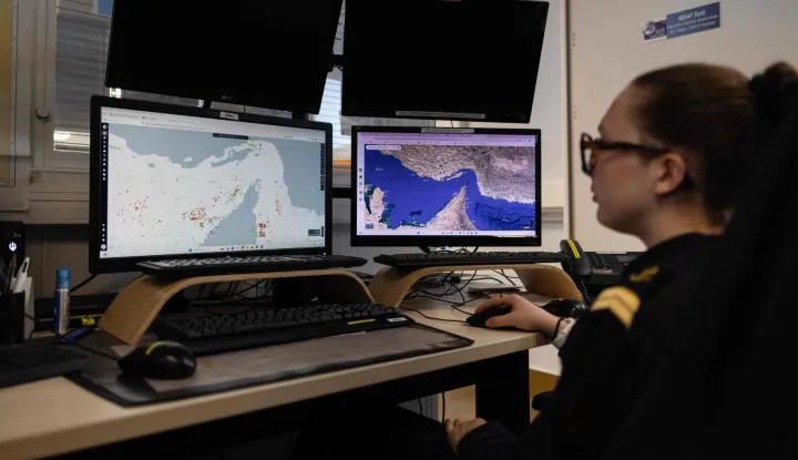 A worker of the Maritime International Cooperation and Awareness (MICA) center looks at screens at the MICA in Brest, western France on April 27, 2026. Attacks on oil tankers in the Strait of Hormuz, piracy off the coast of Somalia, drug trafficking: with their eyes fixed on screens crammed with maps, a dozen sailors at the MICA Centre monitor the world?s maritime hotspots in real time.Since the start of the war in the Middle East, triggered by Israeli-American strikes on Iran on February 28, 2026, this French centre of expertise in maritime security, attached to the French Navy, has been providing invaluable support to civilian vessels and crews stranded in the Persian Gulf. (Photo by Fred TANNEAU/AFP)