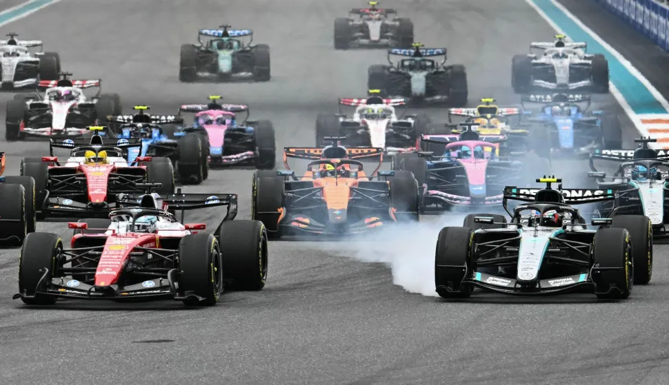 (L/R) Ferrari's Monegasque driver Charles Leclerc and Mercedes' Italian driver Kimi Antonelli race at the front of the pack at the start of the 2026 Miami Formula One Grand Prix at Miami International Autodrome in Miami Gardens, Florida, on May 3, 2026. (Photo by CHANDAN KHANNA/AFP)