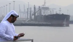 (FILES) An Emirati man stands at the oil terminal of Fujairah during the inauguration ceremony of a dock for supertankers on September 21, 2016. The United Arab Emirates will withdraw from the OPEC and OPEC+ oil cartels on May 1, 2026 state media said on April 28, 2026, calling it a strategic decision by the major producer. (Photo by Karim SAHIB/AFP)