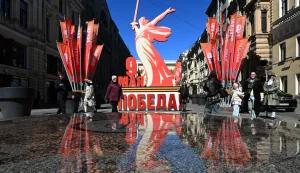 People walk past a decoration featuring a replica of the "Motherland Calls" monument ahead of celebrations of the 81st anniversary of the Soviet Union's victory over Nazi Germany in World War II, in Saint Petersburg on May 6, 2026. (Photo by Olga MALTSEVA/AFP)