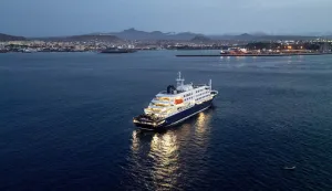 A general view of the cruise ship MV Hondius, while stationary off the port of Praia, the capital of Cape Verde, on May 6, 2026. Two seriously ill crew members on a cruise ship stricken by a deadly hantavirus outbreak will be evacuated via Cape Verde to the Netherlands, allowing the vessel to sail on to Spain's Canary Islands, the ship operator said on May 5, 2026.The MV Hondius has been at the centre of an international health scare since Saturday, when WHO was informed that the rare disease -- usually spread from infected rodents typically through urine, droppings and saliva -- was suspected of being behind the deaths of three of its passengers.As others fell ill, passengers and crew have been in isolation after Cape Verde authorities barred the ship from docking, and as health authorities scrambled to find a port that would take the Hondius. (Photo by AFP)