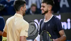 DINO PRIŽMIĆ, NOVAK ĐOKOVIĆ Croatia's Dino Prizmic (R) shakes hands with Serbia's Novak Djokovic after winning their men's singles match of the WTA Rome Open tennis tournament at the Foro Italico in Rome on May 8, 2026. (Photo by Filippo MONTEFORTE/AFP) 