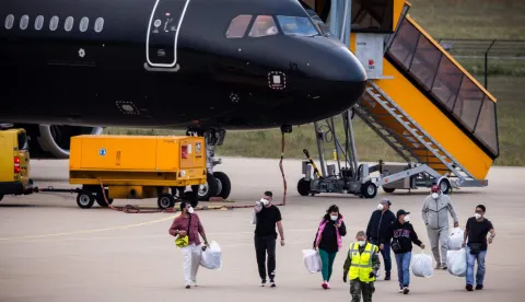 Dutch national passengers and evacuees of the MV Hondius cruise ship, where an outbreak of hantavirus has been detected, disembark from a plane upon their landing at Eindhoven Air Base International airport on May 10, 2026. The evacuation of the approximately 150 passengers and crew members of the MV Hondius, where an outbreak of hantavirus has been detected, began on on May 10, 2026 with the Spanish and French nationals at a port on the island of Tenerife in the Canary Islands; the operation, which is being closely monitored, is set to continue until May 11. The World Health Organisation (WHO) has identified six confirmed cases of hantavirus out of eight suspected cases, including three people who have died from this known but rare virus, for which there is neither a vaccine nor a treatment. (Photo by ROB ENGELAAR/ANP/AFP)/Netherlands OUT