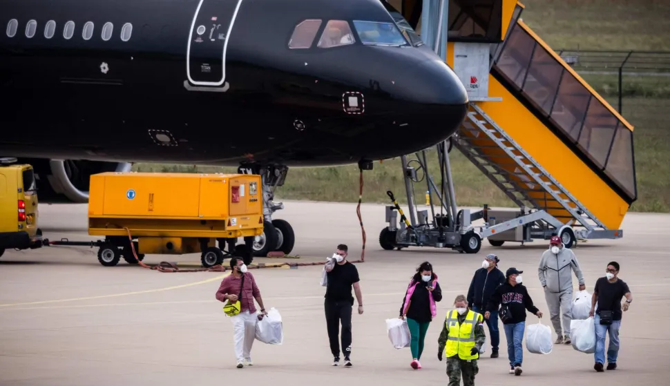 Dutch national passengers and evacuees of the MV Hondius cruise ship, where an outbreak of hantavirus has been detected, disembark from a plane upon their landing at Eindhoven Air Base International airport on May 10, 2026. The evacuation of the approximately 150 passengers and crew members of the MV Hondius, where an outbreak of hantavirus has been detected, began on on May 10, 2026 with the Spanish and French nationals at a port on the island of Tenerife in the Canary Islands; the operation, which is being closely monitored, is set to continue until May 11. The World Health Organisation (WHO) has identified six confirmed cases of hantavirus out of eight suspected cases, including three people who have died from this known but rare virus, for which there is neither a vaccine nor a treatment. (Photo by ROB ENGELAAR/ANP/AFP)/Netherlands OUT
