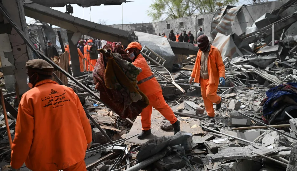 (FILES) Afghan municipality workers clear debris from the site after Pakistani airstrikes hit the Omid Addiction Treatment Hospital in Kabul on March 17, 2026. At least 372 Afghan civilians have been killed?during conflict with Pakistan in the first three months of this year,?the United Nations Assistance Mission in Afghanistan (UNAMA) said on May 12. (Photo by Wakil KOHSAR/AFP)