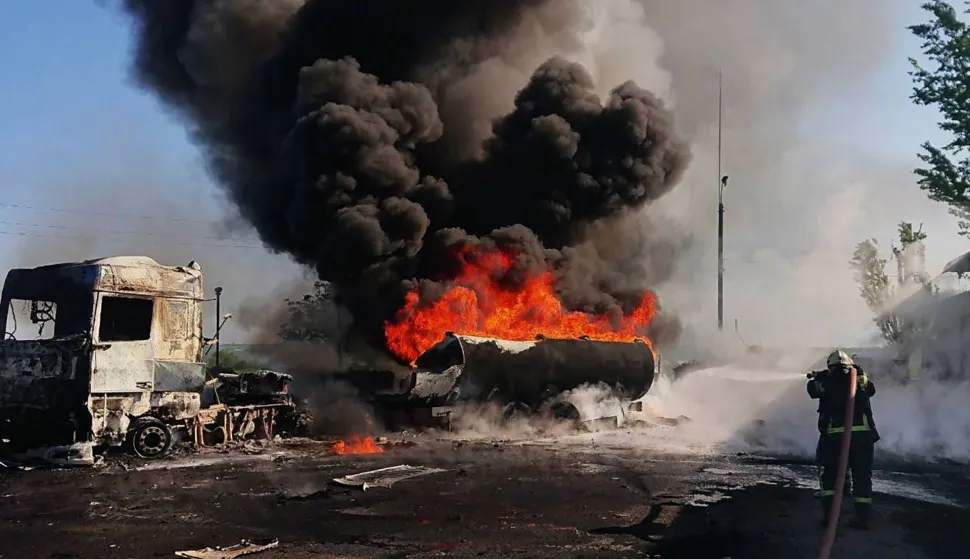 This handout photograph taken and released by the State Emergency Service of Ukraine on May 12, 2026, shows a firefighter holding a hose to attempt to extinguish a fire at the site of an air attack in an undisclosed area of the Dnipro region, amid the Russian invasion of Ukraine. (Photo by Handout/State Emergency Service of Ukraine/AFP)/RESTRICTED TO EDITORIAL USE - MANDATORY CREDIT "AFP PHOTO/State Emergency Service of Ukraine/HANDOUT" - HANDOUT - NO MARKETING NO ADVERTISING CAMPAIGNS - DISTRIBUTED AS A SERVICE TO CLIENTS - AFP CANNOT INDEPENDENTLY VERIFY THE AUTHENTICITY OR LOCATION, DATE, AND CONTENT OF THESE IMAGES./
