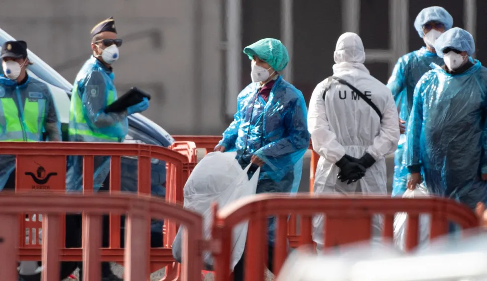Passengers wearing blue protective suits board a military bus as passengers and crew are evacuated from the Dutch flagged hantavirus-stricken cruise ship MV Hondius at the industrial port of Granadilla de Abona on the island of Tenerife in Spain's Canary Islands on May 10, 2026. Repatriation flights for the nearly 150 passengers onboard the ship hit by a deadly hantavirus outbreak are planned to the United States, Britain, France, and other countries, Spain's interior minister announced on Saturday. Most of the nearly 150 people on board will be transferred to shore on smaller vessels then by bus to the airport and then flown home after weeks at sea. (Photo by JORGE GUERRERO/AFP)