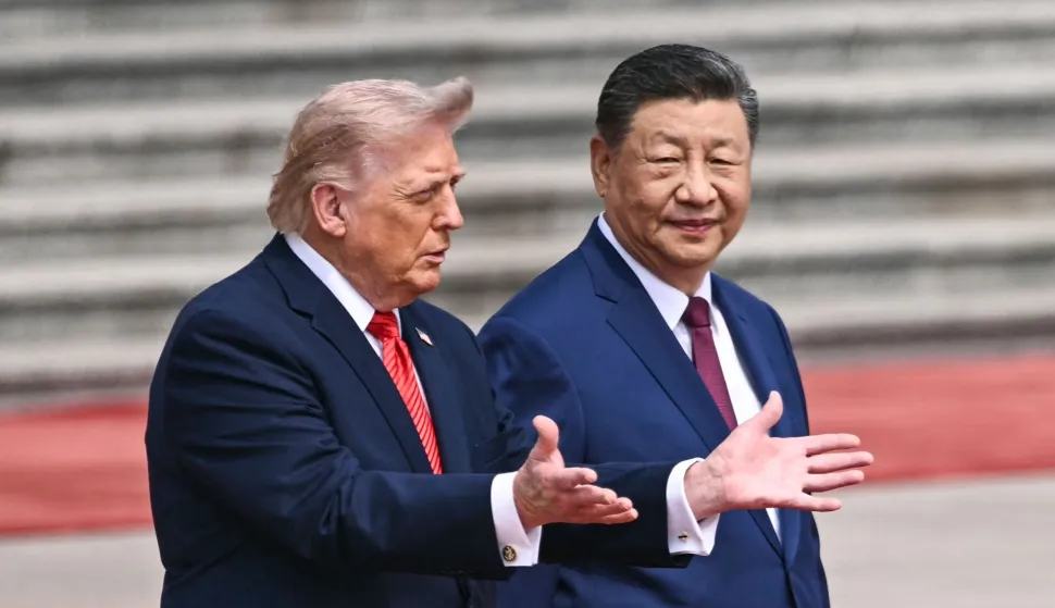 TOPSHOT - US President Donald Trump (L) takes part in a welcome ceremony with China's President Xi Jinping at the Great Hall of the People in Beijing on May 14, 2026. (Photo by Brendan SMIALOWSKI/AFP)