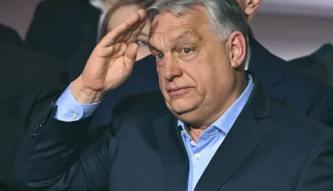 (FILES) Hungary's Prime Minister Viktor Orban salutes to supporters at the Balna centre in Budapest during a general election in Hungary, on April 12, 2026. Hungary's outgoing nationalist prime minister Viktor Orban said on April 25, 2026 he would step back from parliament after his coalition suffered a crushing election defeat that ended his 16 years in power. "Since the seat I won as the lead candidate on the Fidesz-KDNP ticket is, in fact, a parliamentary seat for Fidesz, I have decided to give it back. Right now, I am not needed in Parliament, but in the reorganization of the national camp" he said in a Facebook video. (Photo by Attila KISBENEDEK/AFP)