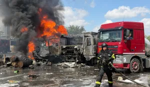 A Ukrainian rescuer works to extinguish a fire following an air attack on an industrial infrastructure facility in Zaporizhzhia on May 15, 2026, amid the Russian invasion of Ukraine. (Photo by Darya NAZAROVA/AFP)