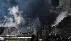 Firefighters extinguish a fire at a site of a strike in the town of Brovary, near Kyiv, following a Russian missile and drone attack, on March 14, 2026, amid the Russian invasion of Ukraine. Russian drone and missile strikes near Ukraine's capital killed two people and wounded four, the regional military administration said on March 14. "Sadly, two people have been killed in the Brovary Raion. Four more have been injured," said Mykola Kalashnyk, the head of Kyiv region's military administration, in a post on Telegram. (Photo by Genya SAVILOV/AFP)